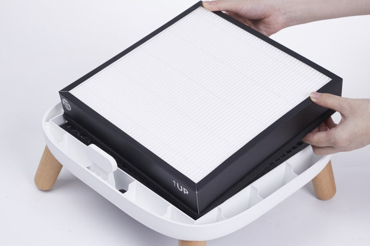 Person placing a HEPA filter onto Smart Air Sqair Air Purifier