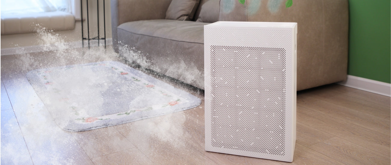 SA600 air purifier in living room with grey couch in background with dusty overlay