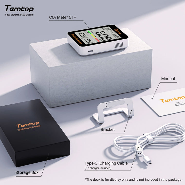 Temtop CO2 Meter C1+ with packaging, charging cable, and manual on a light gray background