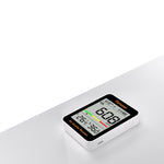 Temtop C1 CO2 Monitor on a grey bench with a white background