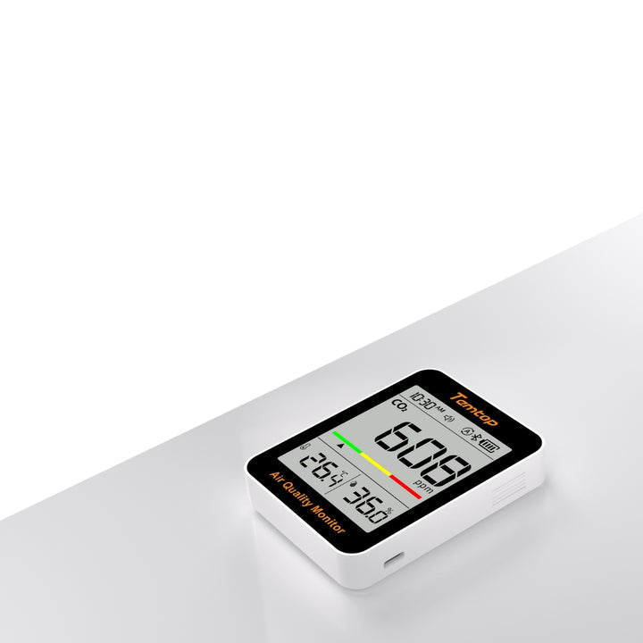 Temtop C1 CO2 Monitor on a grey bench with a white background