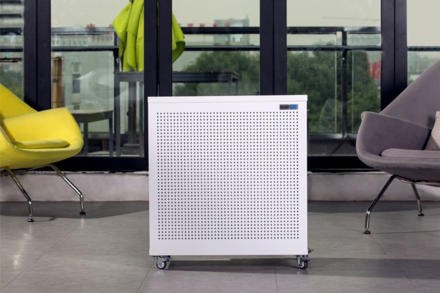 Smart Air blast mini air purifier in a modern spacious room with chairs and large windows.