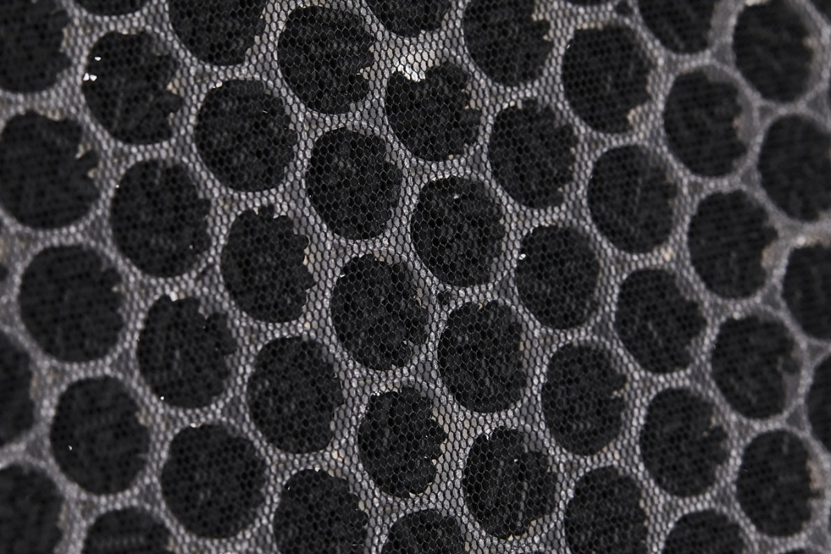 Close-up of activated carbon filter showing pallets in a mesh honeycomb structure