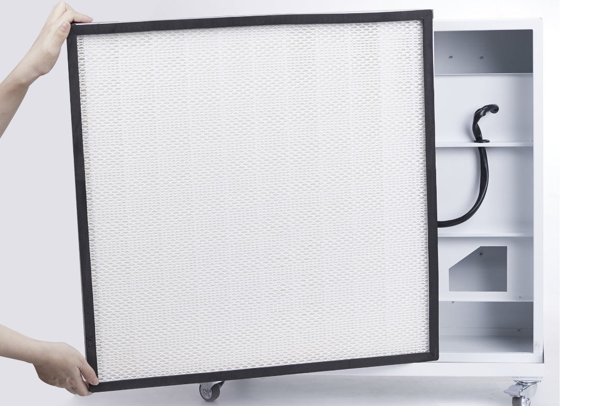 Person holding a large HEPA filter in front of a smart air blast mini air purifier.