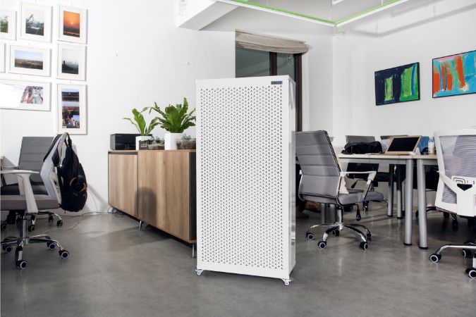 Smart Air Blast Air purifier in an office setting with desks, chairs, and computer monitors.