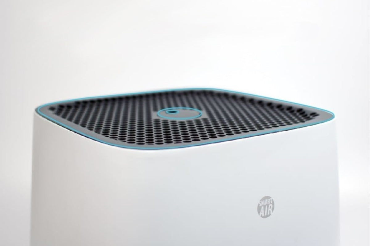 Smart Air Sqair Air purifier close up of top grill and white body on a light grey background