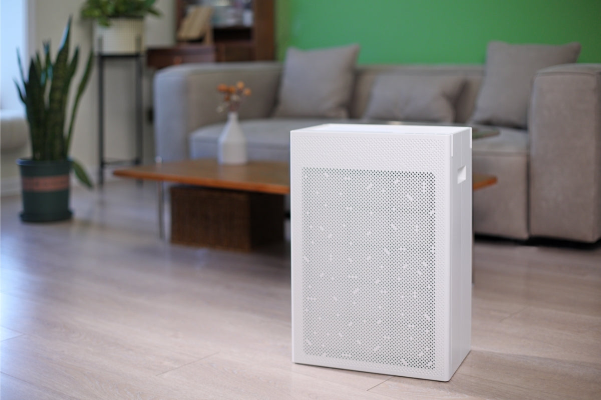 Smart Air SA600 air purifier on a wooden floor with a blurred living room background