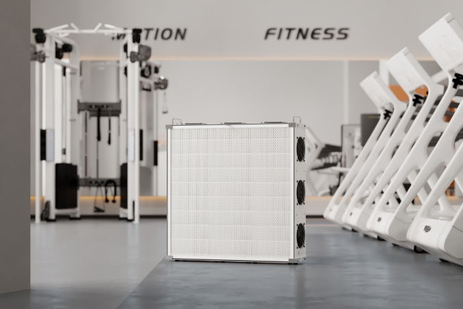 SA700 air purifier in foreground of gym with gym equipment in the background on polished concrete floor