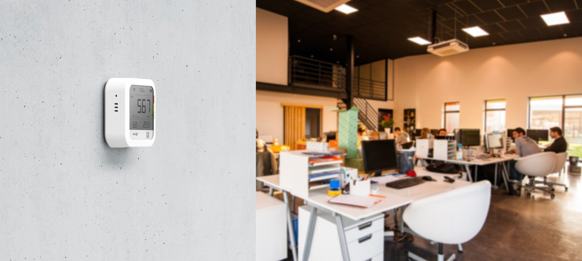 Smart Air CO2 monitor on concrete wall with office activity in the background