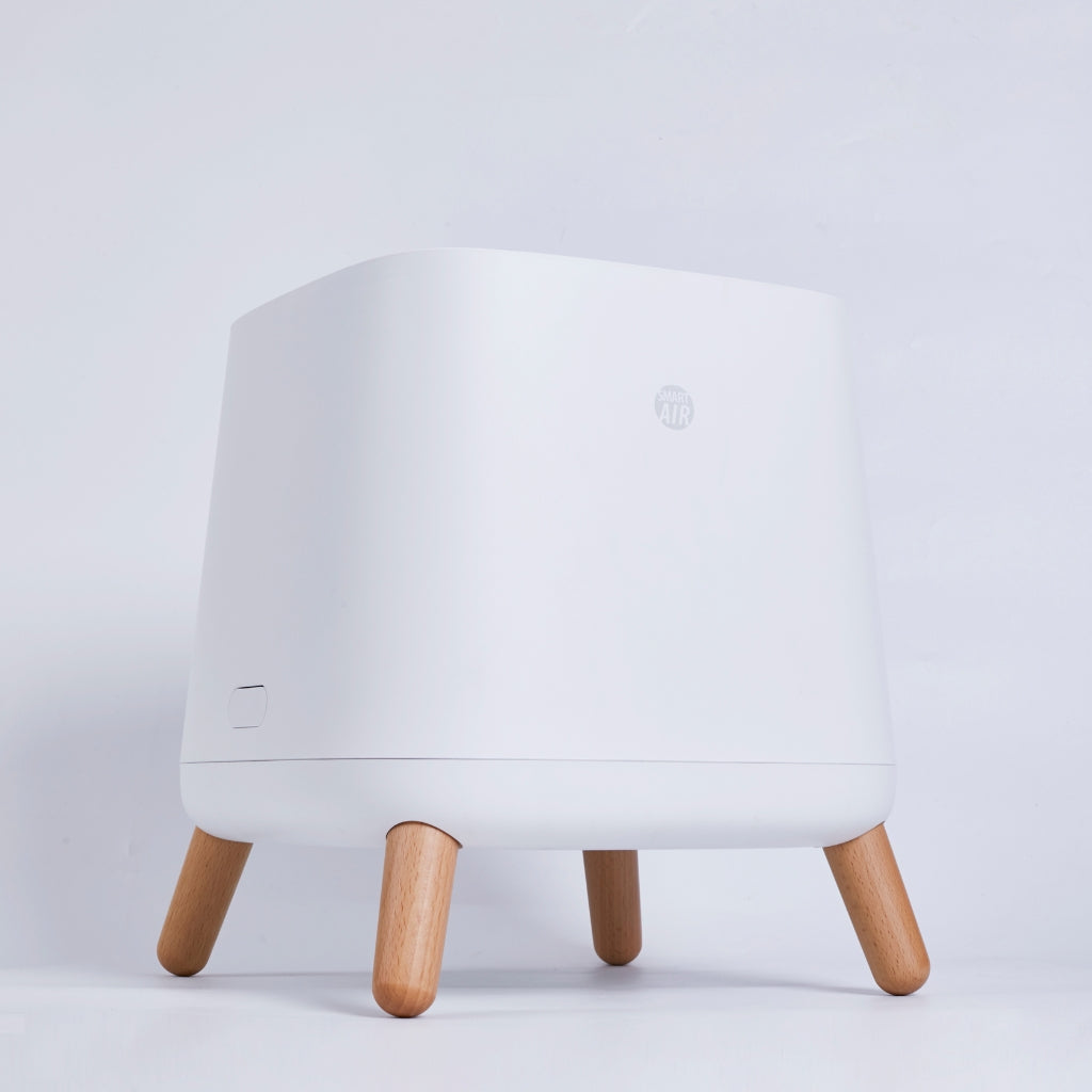 Smart Air Sqair air purifier with wooden legs on a light grey background