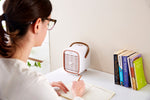 Smart Air QT3 portable Air Purifier on work desk while woman studies