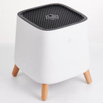 Angled top down view of Smart Air The Sqair Air Purifier and its black grill on white background